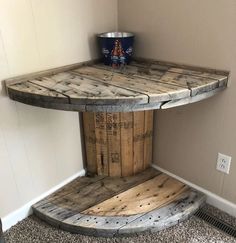 a table made out of wooden pallets with a bucket sitting on top of it