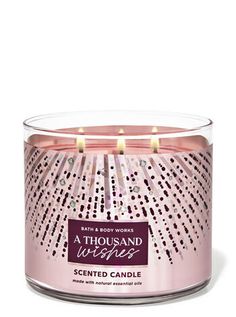 a pink candle that says, a thousand wishes scented candle with an intricate design on the front