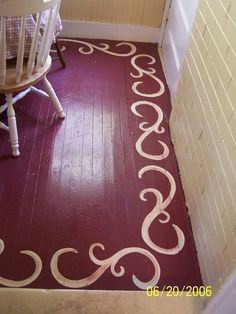 a room with a chair and rug on the floor in front of a door way