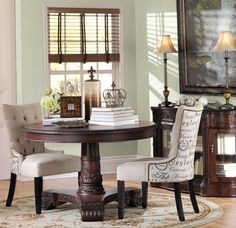 a dining room table with two chairs around it