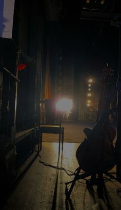 the light is shining brightly in the dark room with two chairs and a chair on the floor