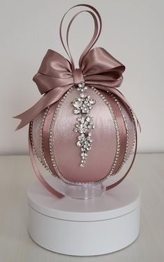 a pink ornament with a bow on it