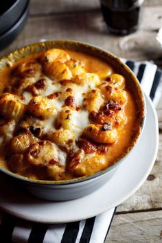 a bowl filled with food on top of a white plate