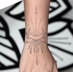 a woman's hand with a tattoo on it and an image of a flower