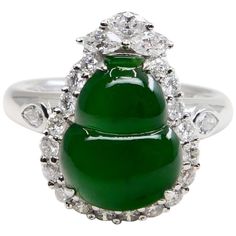 Here is an intense green Jade, very borderline true imperial jade color. This jade and diamond cocktail ring has a mystic subtle glow. It is certified by 2 labs The jade gourd represents the Fulu double, it protects people's happiness. It also means "financial resources are rolling". This vintage ring is set in 18k white gold and diamonds. We estimate the near colourless pear, marquis and round shaped diamonds in this ring setting total about 1.25 cts. The untreated / un-enhanced natural jade has a nice saturation of intense green color. This is one of those rings that you would notice across the room at a party. The ring is stunning. Not only is the green intense and dense, the subtle glow is mesmerising. Photos does not do this ring justice. A collector would want this piece for their co Jade Diamond Rings, Sugar Cookie Jade Wedding Ring, Luxury Jade Rings Fine Jewelry, Jade Diamond Engagement Ring, Luxury Jade Rings In Fine Jewelry Style, Jade Ring Crystal, Luxury Jade Wedding Ring, Luxury Polished Jade Rings, Imperial Jade