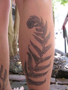 two people with tattoos on their legs