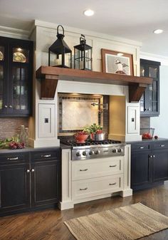 an image of a kitchen with black cabinets and white counter tops, including a stove top oven