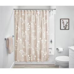 a bathroom with a shower curtain, toilet and sink