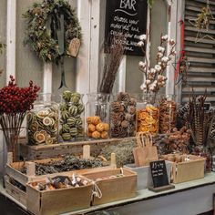 an outdoor market with lots of different types of food and decorations on the outside wall