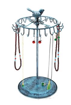 a metal jewelry stand with several necklaces hanging from it's hooks and beads