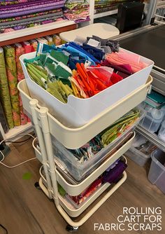 the rolling cart for fabric scraps is full of different colors and sizes in it