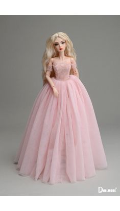 a barbie doll wearing a pink dress on a gray background with the caption's name below it