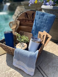 a basket filled with personal items sitting on top of a table next to a pool