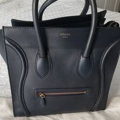 Celine Tote. Good Condition. I Took Pictures Of All The Imperfections. Please See All The Pictures. Blue Smooth Leather Gold-Tone Hardware Rolled Handles Single Exterior Pocket Zip Closure At Top Protective Feet At Base Includes Celine Dust Bag, Tag, Booklet And Proof Of The Payment. I Accept Reasonable Offers. 12’’ H X 12’’ W X 7’’ D, And It Has A Handle Drop: 5" The Mini Celine Luggage Handbag Can Be Carried By Hand Or Worn On The Arm, And It’s Large Enough For All Your Essentials Plus Large Envelopes Or Pamphlets. Celine Tote, Mini Luggage, Pictures Blue, Large Envelope, Celine Luggage, Bag Tag, Womens Tote Bags, Smooth Leather, Calf Skin