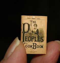 the peoples cookbook is held in someone's hand