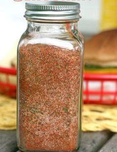 a jar filled with lots of red stuff on top of a table