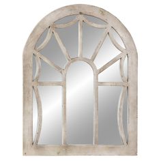 a white arched window mirror on a wall