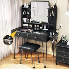 a black vanity with mirror and stool next to it