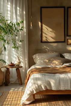 a bed sitting in a bedroom next to a window with sun shining through the curtains