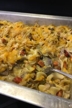 a casserole dish with noodles, meat and vegetables in it is ready to be eaten