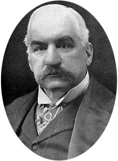 an old black and white photo of a man in a suit with a moustache