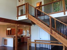 an open floor plan with stairs leading up to the kitchen