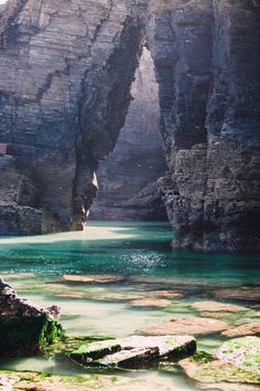 the water is crystal blue and green in this area with large rocks on both sides