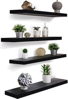 three black shelves with pots and plants on them