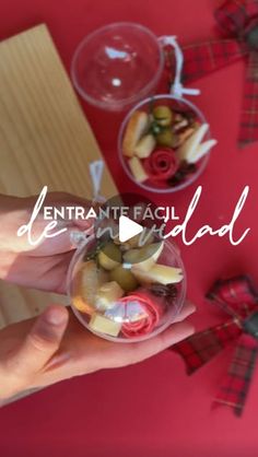 a person holding a glass bowl filled with fruit