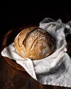 a loaf of bread sitting on top of a white cloth