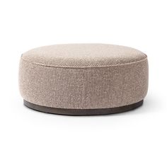 a round ottoman that is made out of fabric