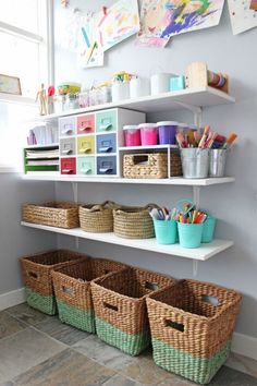 some baskets are sitting on the shelves in this kids's playroom, and there is