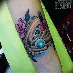 a woman's arm with a tattoo on it that has an image of a bird and flowers