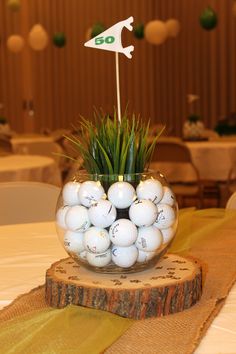 a vase filled with golf balls on top of a table