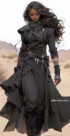 a woman with long hair walking in the desert wearing black clothing and boots, holding her hand on her hip