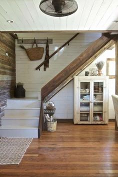 a living room with wooden floors and white walls