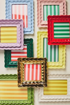 multicolored square shaped glass plates arranged on a wall