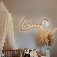 a baby's room with a crib, teddy bear and lights on the wall