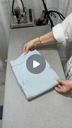 a woman is making a t - shirt with her hands