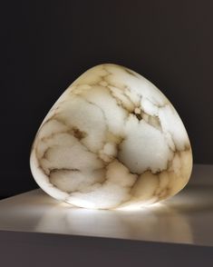 a white marbled object sitting on top of a table