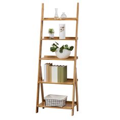 a tall wooden shelf with books and pictures on the top, against a white background