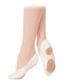 a woman's white ballet shoes with gold accents