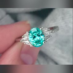 Gorgeous 8x6mm Oval Cut Paraiba Tourmaline With Baguette Accents In A White Gold Plated Solid Sterling Silver Ring, Stamped S925 Is A Unique One Of A Kind Handmade Design. Baguette, Paraiba Tourmaline Engagement Ring, Sparkly Rings, Paraiba Tourmaline Ring, Hand Rings, Sparkly Ring, Paraiba Tourmaline, Right Hand Rings, 925 Ring