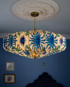 a blue room with a chandelier hanging from the ceiling