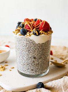 an oatmeal in a glass topped with berries and granola