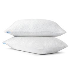 two pillows sitting side by side on top of each other in front of a white background