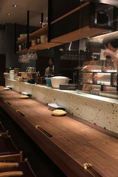 a man is working behind the counter in a restaurant