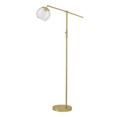 a gold floor lamp with a glass ball on the top and a metal pole at the base