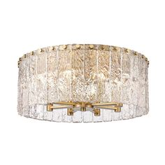 a light fixture with glass shades on the bottom and gold trimmings around it