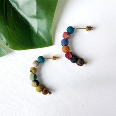 These Kantha Petite Arc Earrings are bold yet understated. Seven colorful Kantha textile beads come together to form a slight arc. Each piece is made from recycled Kantha textiles, so colors and patterns are all one-of-a-kind and will vary. Measures 1" long and finished with nickel and lead-free ear wires. Sustainably handmade by women artisans in India. Orb Necklace, Women Art, Free Earrings, Women Artisans, Ear Wires, Female Art, Statement Necklace, Textiles, Beads